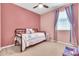 Bedroom with pink walls, ceiling fan, and carpet flooring at 4455 W Suncup Dr, San Tan Valley, AZ 85144