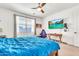Cozy bedroom features a ceiling fan, a window, and a TV for relaxing entertainment at 4455 W Suncup Dr, San Tan Valley, AZ 85144