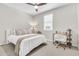 Bedroom with a ceiling fan, desk, and lamp at 4455 W Suncup Dr, San Tan Valley, AZ 85144