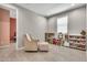 Bonus room with wood-look floors and an alcove with a chair and ottoman at 4455 W Suncup Dr, San Tan Valley, AZ 85144