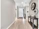 Inviting foyer with light wood floors, console table, and stylish decor at 4455 W Suncup Dr, San Tan Valley, AZ 85144