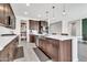 Bright, open kitchen with stainless appliances, center island, and adjacent pantry and dining areas at 4455 W Suncup Dr, San Tan Valley, AZ 85144