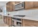 Modern kitchen with stainless steel oven, gas cooktop, white subway tile backsplash, and quartz countertops at 4455 W Suncup Dr, San Tan Valley, AZ 85144