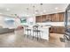 Open-concept kitchen featuring a large island, stainless steel appliances, and wood-look flooring at 4455 W Suncup Dr, San Tan Valley, AZ 85144