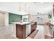Spacious kitchen with an island, stainless steel appliances, and open to the dining and living spaces at 4455 W Suncup Dr, San Tan Valley, AZ 85144