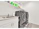 A laundry room with washer and dryer, plus a sink at 4455 W Suncup Dr, San Tan Valley, AZ 85144