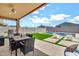 Covered patio with BBQ and outdoor furniture overlooking a pool and lush backyard at 4455 W Suncup Dr, San Tan Valley, AZ 85144