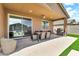 Covered patio offers an outdoor dining space with a grill, overlooking the backyard at 4455 W Suncup Dr, San Tan Valley, AZ 85144