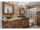 Luxurious bathroom with double vanity sinks, granite countertops, and a glass block walk-in shower at 4507 E Duane Ln, Cave Creek, AZ 85331