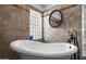 Bright bathroom featuring freestanding tub with tiled walls and window for natural light at 4507 E Duane Ln, Cave Creek, AZ 85331