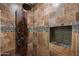 This bathroom shower has tile walls, rain head shower, and a decorative tile accent shelf at 4507 E Duane Ln, Cave Creek, AZ 85331