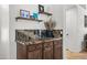 Stylish counter with dark wood cabinets and granite countertop, a functional space for serving and storage at 4507 E Duane Ln, Cave Creek, AZ 85331