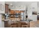 Updated kitchen with stainless steel appliances, pendant lights, marble countertops, and breakfast bar seating for entertaining at 4507 E Duane Ln, Cave Creek, AZ 85331