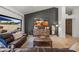 Comfortable living room featuring a leather sofa, a modern entertainment center, and access to the outdoor patio at 4507 E Duane Ln, Cave Creek, AZ 85331