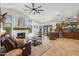 Bright and airy living room with a fireplace, modern ceiling fan, and an open floor plan to the kitchen and dining area at 4507 E Duane Ln, Cave Creek, AZ 85331