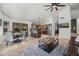 Open concept living room features a modern ceiling fan, adjacent to the dining area and updated kitchen with marble counters at 4507 E Duane Ln, Cave Creek, AZ 85331