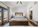 A spacious main bedroom featuring hardwood floors, ensuite bathroom, and sliding glass doors leading to the pool at 4507 E Duane Ln, Cave Creek, AZ 85331