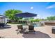 Charming patio area with lounge chairs, umbrella, and view of the pool and backyard at 4507 E Duane Ln, Cave Creek, AZ 85331