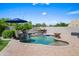 Inviting pool area with waterfall feature, surrounded by a brick patio and shaded umbrellas at 4507 E Duane Ln, Cave Creek, AZ 85331