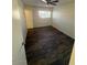 Cozy bedroom featuring wood-like floors and a window with natural light at 4625 W Thomas Rd # 48, Phoenix, AZ 85031