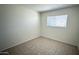 Neutral bedroom has tile flooring and a window letting in natural light at 4625 W Thomas Rd # 48, Phoenix, AZ 85031