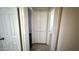 Hallway featuring a built-in storage closet and tile flooring at 4625 W Thomas Rd # 48, Phoenix, AZ 85031