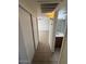 Hallway view features a bathroom and closet with neutral decor at 4625 W Thomas Rd # 48, Phoenix, AZ 85031