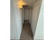 Hallway with neutral walls and tiled flooring leading to closet at 4625 W Thomas Rd # 48, Phoenix, AZ 85031