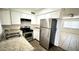 Well-maintained kitchen featuring stainless steel appliances, bright white cabinets, and laminate wood flooring at 4625 W Thomas Rd # 48, Phoenix, AZ 85031