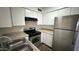 Bright kitchen featuring stainless steel appliances, laminate countertops, and laminate wood flooring at 4625 W Thomas Rd # 48, Phoenix, AZ 85031
