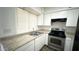 Bright kitchen with white cabinets, stainless steel appliances, and laminate countertops at 4625 W Thomas Rd # 48, Phoenix, AZ 85031