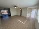 Open living room featuring tile floors, ceiling fan, and backyard access at 4625 W Thomas Rd # 48, Phoenix, AZ 85031