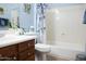 Bright bathroom with a white vanity, toilet and shower with a floral shower curtain at 4778 E Sourwood Dr, Gilbert, AZ 85298
