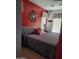 Cozy bedroom with red accent wall, geometric valances and a comfortable bed at 4778 E Sourwood Dr, Gilbert, AZ 85298