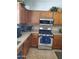 A cozy kitchen boasts wood cabinets, stainless steel appliances and granite countertops at 4778 E Sourwood Dr, Gilbert, AZ 85298