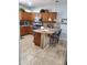 A cozy kitchen boasts wood cabinets, pendant lights, an island with bar seating, and stainless appliances at 4778 E Sourwood Dr, Gilbert, AZ 85298