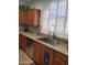 A well-lit kitchen features wooden cabinets, stainless steel appliances, and a modern sink at 4778 E Sourwood Dr, Gilbert, AZ 85298