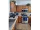 A cozy kitchen features wood cabinets, stainless steel appliances, and granite countertops at 4778 E Sourwood Dr, Gilbert, AZ 85298