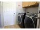 Laundry room with front load washer and dryer and overhead cabinets at 4778 E Sourwood Dr, Gilbert, AZ 85298