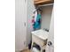 Functional laundry area with a utility sink and storage space, adjacent to a closed door at 4778 E Sourwood Dr, Gilbert, AZ 85298