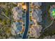 Aerial view showcases homes in a community featuring intricate roof designs and neatly lined streets with greenery at 5100 E Rancho Paloma Dr # 1044, Cave Creek, AZ 85331