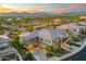 Stunning aerial view of a large home with a stone facade, tile roof, and landscaped grounds, all set against mountain views at 5100 E Rancho Paloma Dr # 1044, Cave Creek, AZ 85331