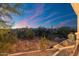 Expansive backyard views from the house featuring native desert vegetation against a colorful evening sky at 5100 E Rancho Paloma Dr # 1044, Cave Creek, AZ 85331