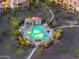 A tranquil community pool area with lounge chairs and umbrellas, set among lush landscaping, creating a resort-like atmosphere at 5100 E Rancho Paloma Dr # 1044, Cave Creek, AZ 85331