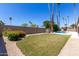 Expansive backyard with a lush lawn, privacy fence, and mature trees, offering ample space for recreation and gardening at 5211 E Winchcomb Dr, Scottsdale, AZ 85254