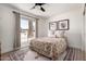 Cozy bedroom with a ceiling fan, natural light, and classic decor at 5211 E Winchcomb Dr, Scottsdale, AZ 85254