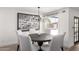 Dining room area with a modern chandelier, dining table set, and access to the patio at 5211 E Winchcomb Dr, Scottsdale, AZ 85254