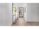 Bright hallway with views to the front yard with console table and tiled floors at 5211 E Winchcomb Dr, Scottsdale, AZ 85254