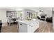 Open concept kitchen with island, dining area, and living room with access to the backyard pool at 5211 E Winchcomb Dr, Scottsdale, AZ 85254