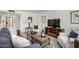 Cozy living room showcasing comfortable seating, stylish decor, a media console, and a patterned rug at 5211 E Winchcomb Dr, Scottsdale, AZ 85254